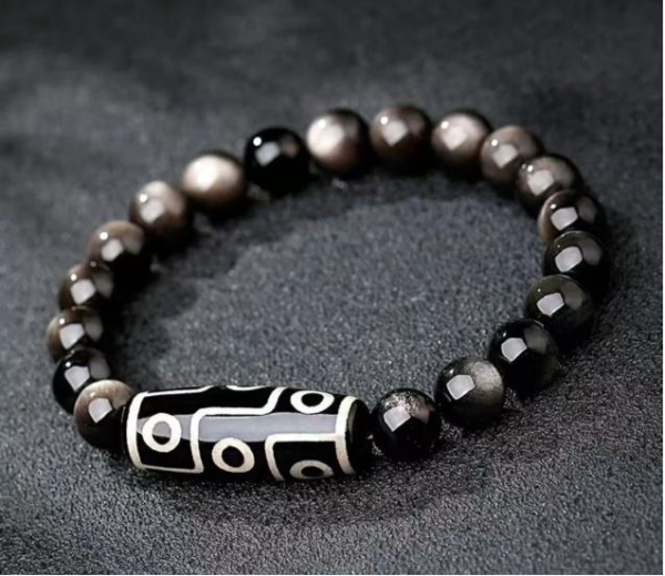 Black obsidian bead bracelet with black-and-silver patterned tube centerpiece