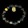 Gold obsidian protection bracelet with teal-blue glassy beads, gold spacers, and heart charm
