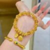 Gold citrine beaded bracelet with coin and bar charms