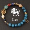 Beaded zodiac planet energy bracelet with blue stones, gold charms, Leo
