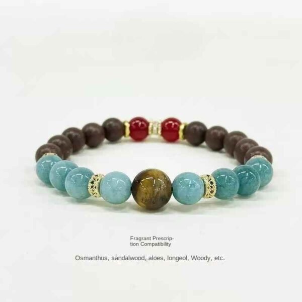Beaded herbal sleep aid bracelet with dark brown, aqua, red beads and gold spacers