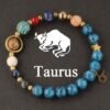 Beaded zodiac planet energy bracelet with blue stones, gold charms, Taurus