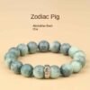 Green bodhi bead bracelet with mixed light and dark green carved beads, metal charm
