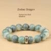 Green bodhi bead bracelet with carved beads and central metal talisman charm