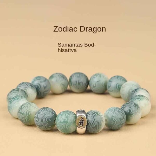 Green bodhi bead bracelet with carved beads and central metal talisman charm