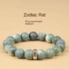 Green bodhi bead bracelet with carved round beads and gold-toned center zodiac charm