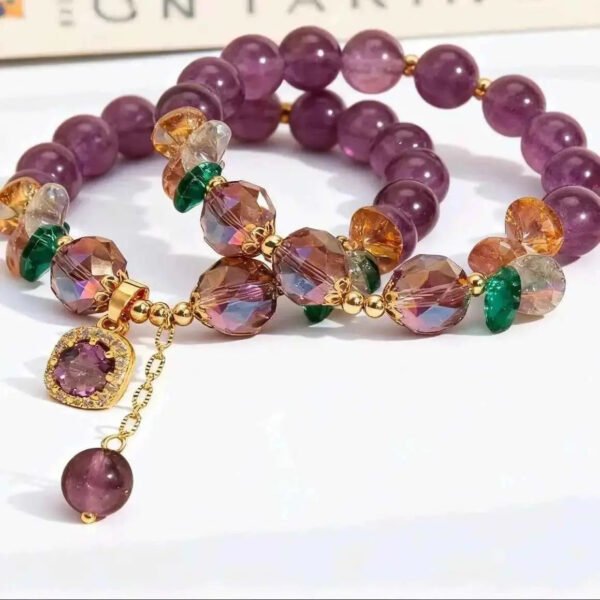Amethyst gemstone bracelet featuring purple beads, faceted multicolor stones, and a dangling purple charm.