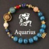 Aquarius zodiac energy bracelet with blue beaded strand and gold star charm, round medallion